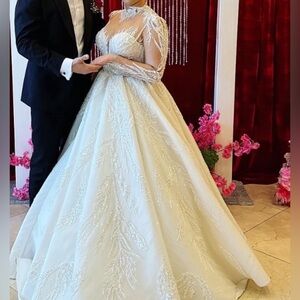 Selling a beautiful wedding dress worn once! Dry cleaned like new! Custom made!